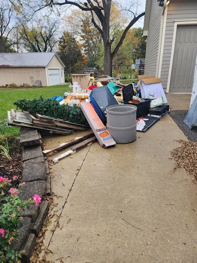 Dumpster being loaded with debris for Estate Cleanout Dumpster Rental in Orchard City